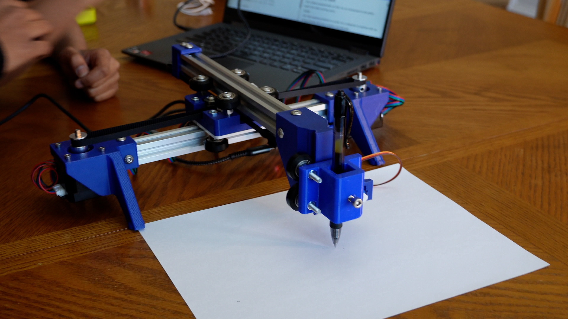 The completed blot drawing machine above a piece of paper.